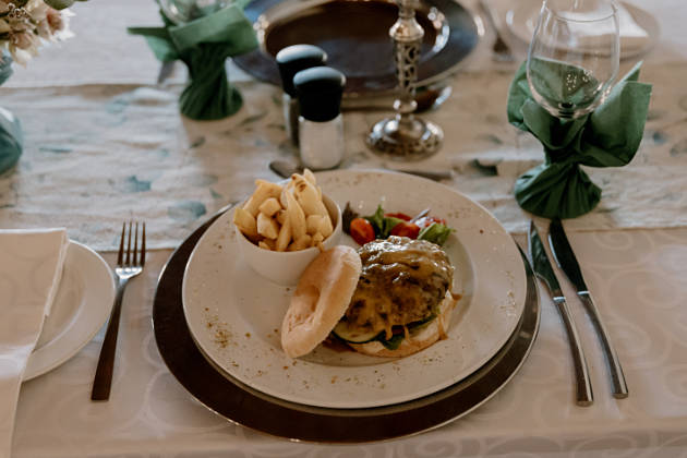 Burger and chips on table