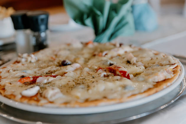 Pizza served at restaurant at Chandelier